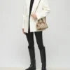3d270a51-ee79-4fa4-b0cf-3c5d2edd064e20231202012210 Tory Burch Mini T Monogram duffle bag Hazelnut