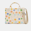 Untitled design - 2025-12-23T221510.445 THE MARC JACOBS Wild Daisy CANVAS MEDIUM TOTE BAG